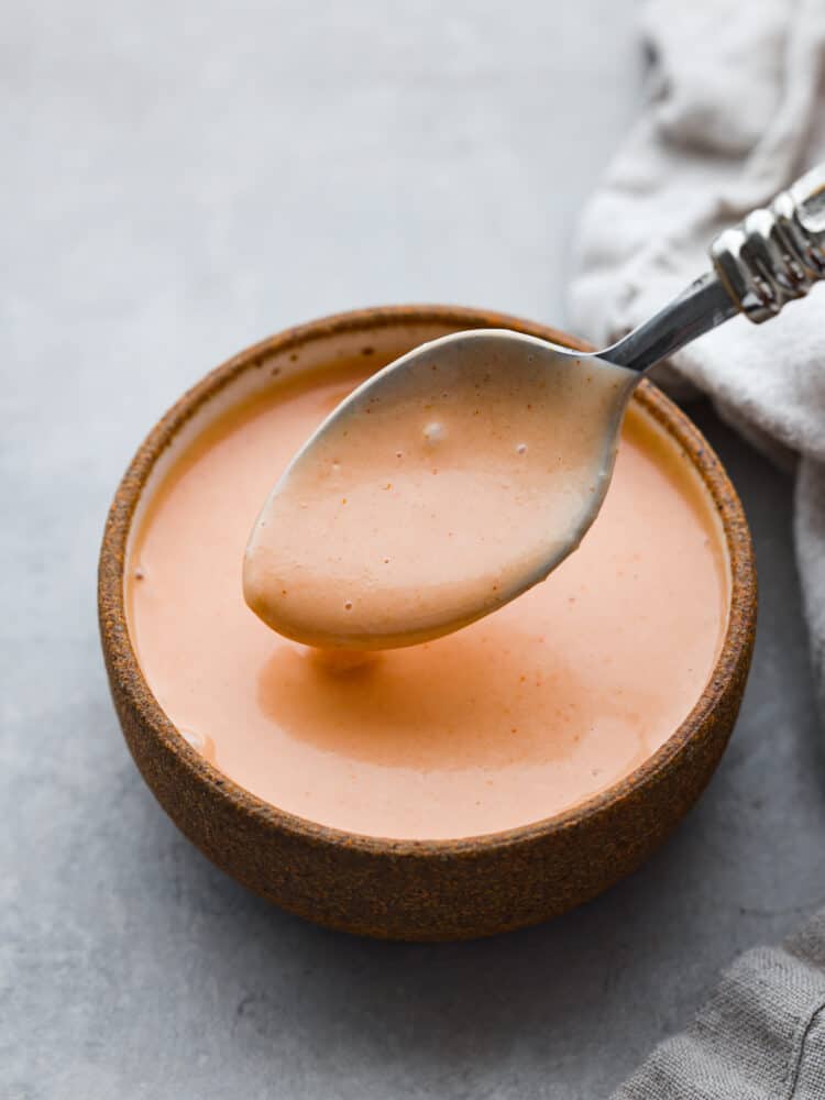 The name says it all because this comeback sauce keeps you coming back for more again and again! Itโs tangy, creamy, savory, and is perfect for using as a dip or a spread. Hero image of comeback sauce in a brown stoneware bowl, being scooped up with a metal spoon.