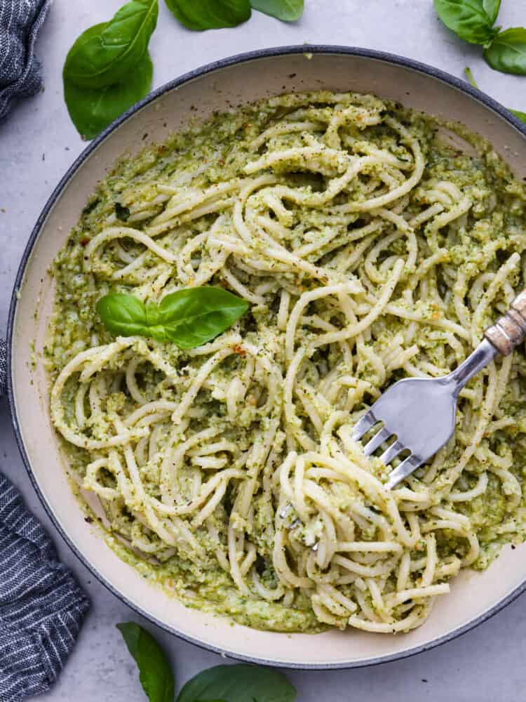 This creamy pesto sauce is so bright and packed with fresh flavor, and the best part is there is no cooking required! This quick and easy creamy sauce is ready in just 15 minutes and is perfect on your favorite cooked pasta. A bowl of pasta with creamy pesto on top.