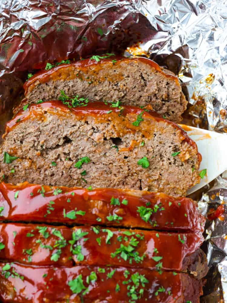 Meatloaf is a classic comfort food that is loved by the whole family! This recipe for crockpot meatloaf is easy to prepare, and using your slow cooker allows the flavors to blend together for a delicious meal. Closeup of a slice of meatloaf.