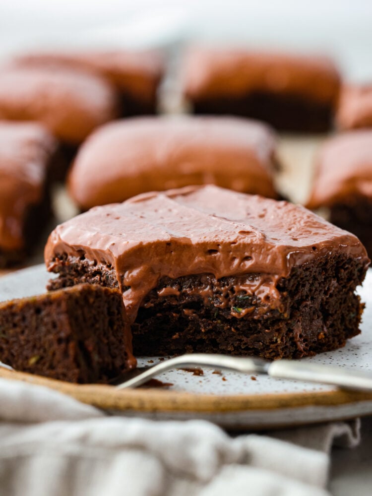 Healthy brownies are your new guilt-free indulgence! They have way less sugar and healthy ingredients like zucchini and yogurt to make a delicious dark chocolate brownie that is moist and even better than regular brownies. Chocolate healthy brownies with a scoop taken out of it on the fork.
