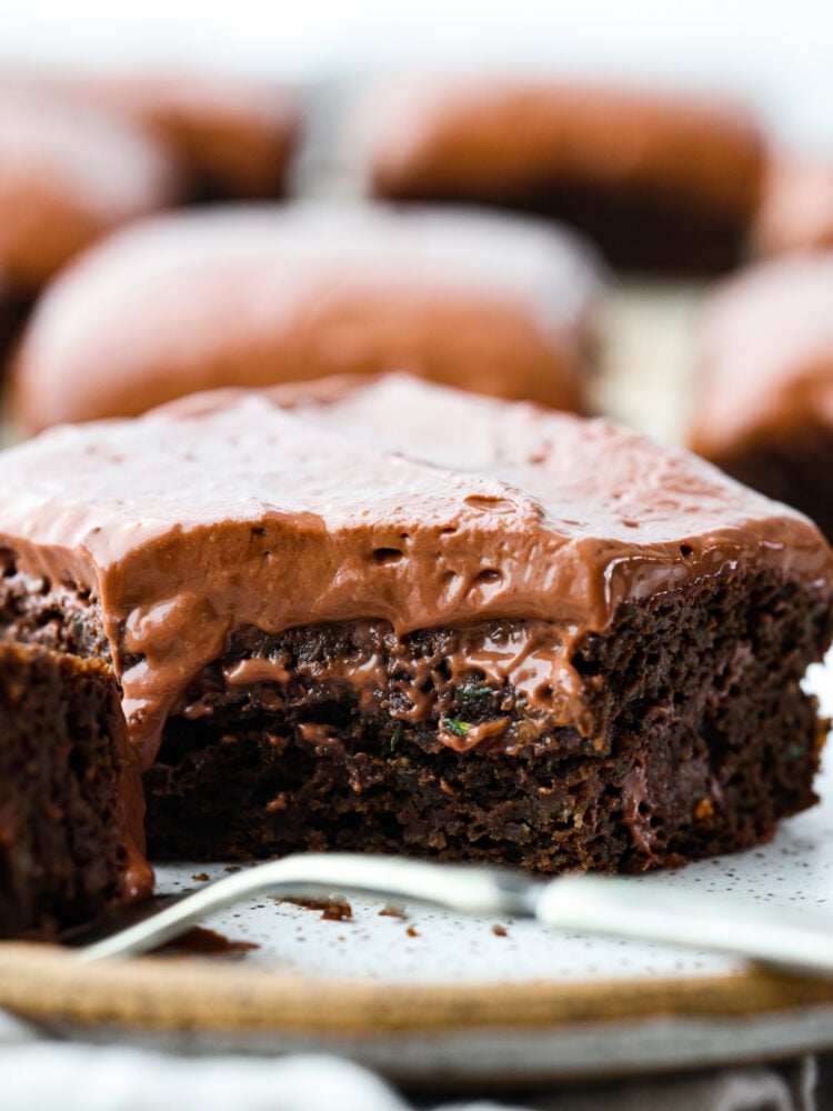 Healthy brownies are your new guilt-free indulgence! They have way less sugar and healthy ingredients like zucchini and yogurt to make a delicious dark chocolate brownie that is moist and even better than regular brownies. A close up on the healthy brownies with a scoop taken out of it.