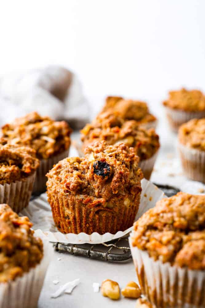 Morning Glory muffins are hearty and nutrient packed muffins that are the perfect way to start your day! Full of filling ingredients like flaxseed, coconut, carrot, and sunflower seeds, this muffin is flavorful and will keep you satisfied until lunch. Morning glory muffins on a wire rack.