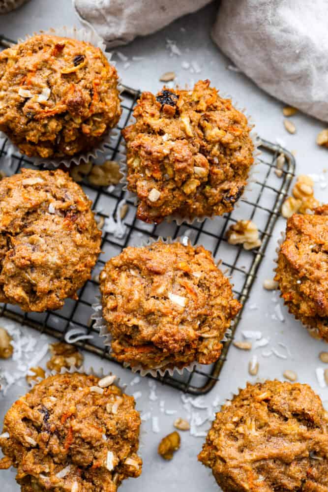 Morning Glory muffins are hearty and nutrient packed muffins that are the perfect way to start your day! Full of filling ingredients like flaxseed, coconut, carrot, and sunflower seeds, this muffin is flavorful and will keep you satisfied until lunch. An overhead view of the morning glory muffins on the wire rack.