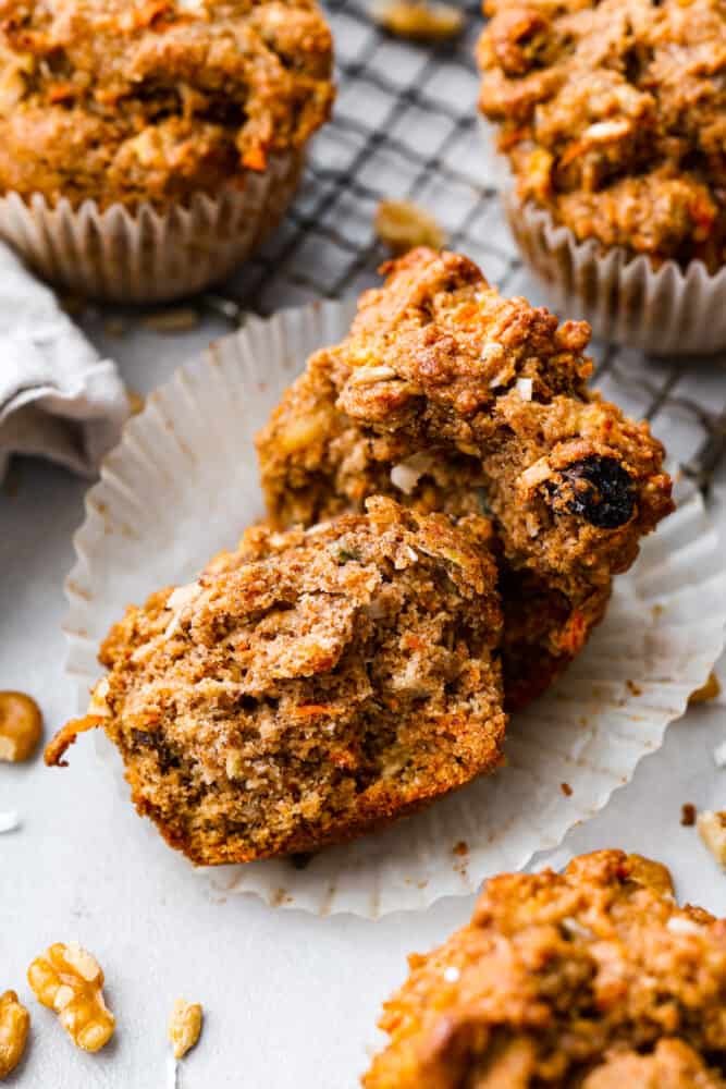 Morning Glory muffins are hearty and nutrient packed muffins that are the perfect way to start your day! Full of filling ingredients like flaxseed, coconut, carrot, and sunflower seeds, this muffin is flavorful and will keep you satisfied until lunch. A muffin cut in half to show the insides.