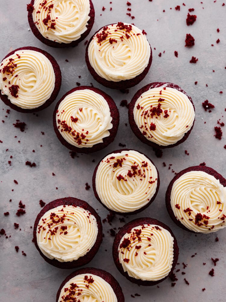 These red velvet cupcakes are perfectly moist cake with the most beautiful and deep red color. They are topped with classic cream cheese frosting, and once you eat one, you will agree that these are the best! Top-down view of red velvet cupcakes.
