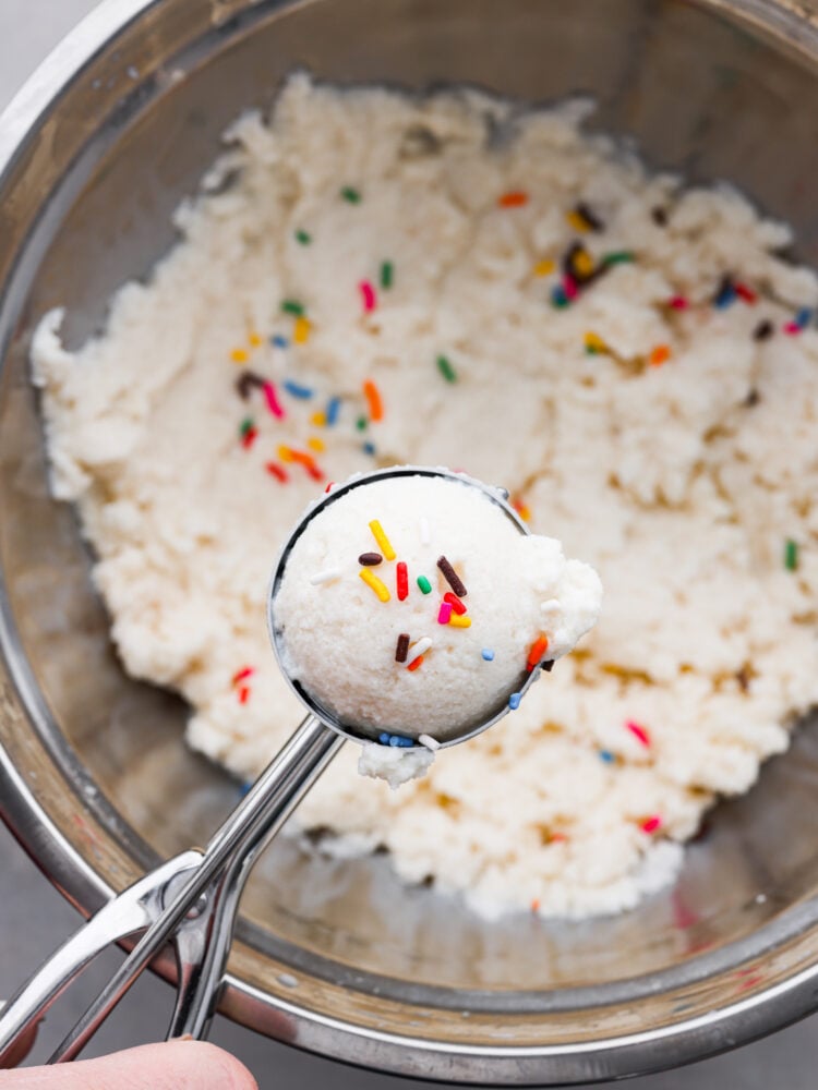 Snow Ice Cream is as fun as it sounds! Let your inner child out and scoop up some freshly fallen snow to make this delicious frozen treat. It's thickened with sweetened condensed milk and flavored any way you want. It's hands-down my favorite snow day treat! Snow ice cream in a bowl being scooped out with a cookie scoop.
