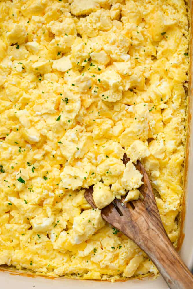 Get ready for the best scrambled eggs you've ever had (that also happen to be the easiest to make)! These Baked Scrambled eggs are light, fluffy, and full of flavor, and perfect for food prepping, holiday breakfasts, or just having enough food on the table to keep everyone full until lunch. A close up on the baked scrambled eggs.
