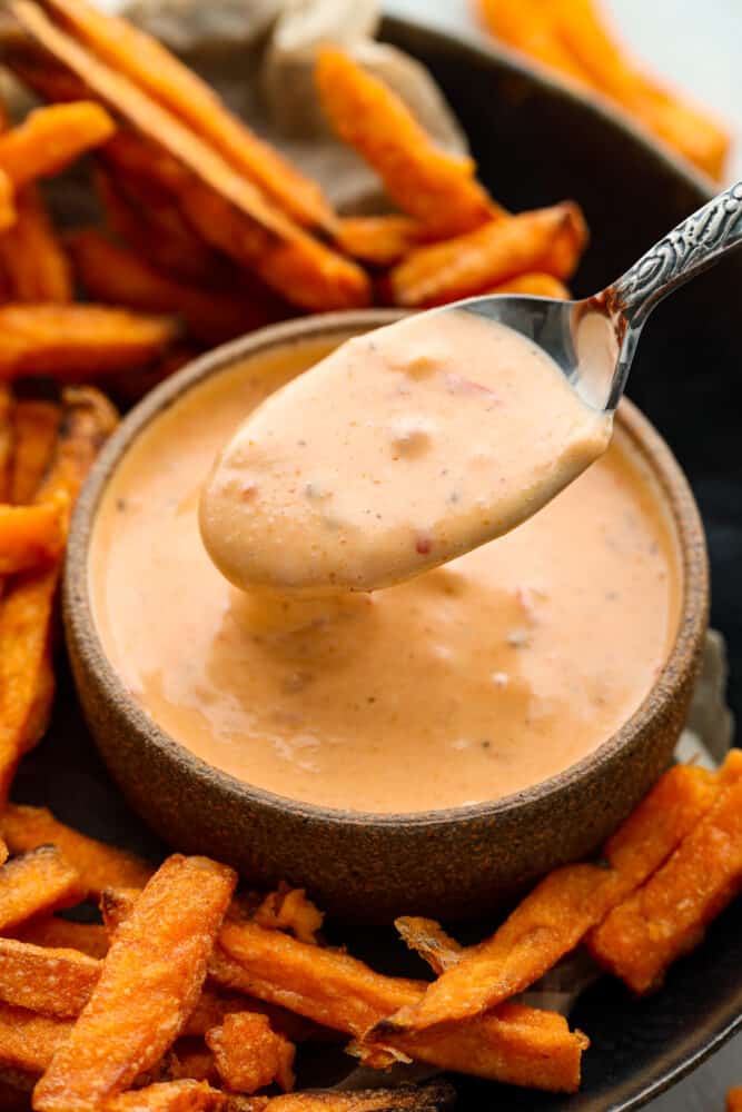 Boom Boom Sauce is a sweet and spicy mayonnaise-based sauce that is perfect for dipping! It takes 5 minutes to whip up and is so full of flavor, making it perfect for fries, onion rings, and so much more. Boom boom sauce in a bowl with sweet potato fries