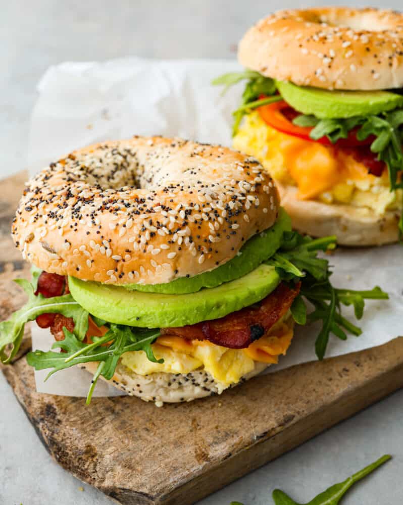 Start your morning off right with this hearty and filling Bagel Breakfast Sandwich. It has everything you need to fuel your body and to keep you full until lunch. These are also perfect for breakfast on the go and always hit the spot! A close up on the bagel breakfast sandwiches.