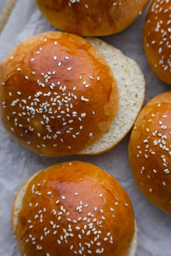 A good hamburger bun can make all the difference! This Brioche Bun is hands down the BEST bun for hamburgers, sloppy joes, and so much more. It's fluffy, soft, and oh so good. A close up on a brioche bun that has been sliced open.