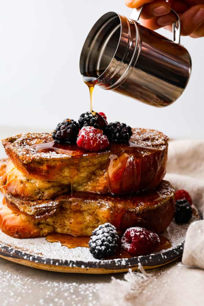 Move over regular French toast, there's a new brunch boss in town and it's made with brioche bread! With its buttery richness and pillowy texture, it's like biting into a cloud of happiness. Trust me, once you've had brioche French toast, there's no going back to the basic stuff. Itโs breakfast, elevated! Syrup being poured over French toast.