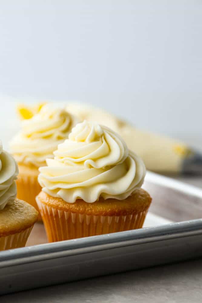Let me just say, when it comes to frosting, I know what I’m doing. I’ve whipped, piped, and taste-tested my way through more buttercream frosting than I care to admit, and this one? It’s the gold standard. Yellow cake cupcake frosted with buttercream frosting.