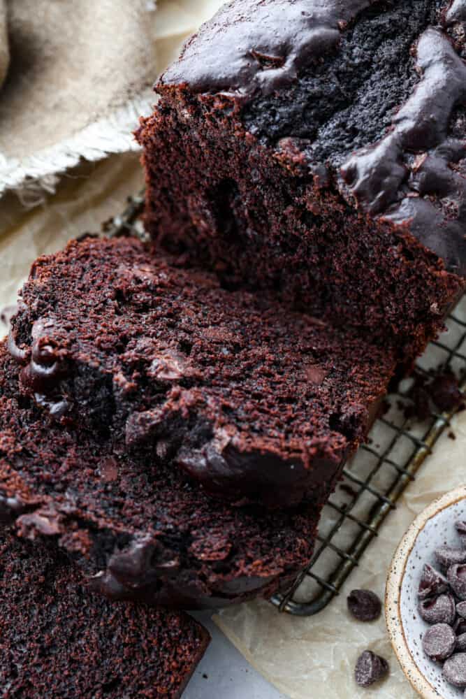 This bread is every chocolate loverโs dream! Moist and soft with deep chocolatey flavor, you wonโt be able to stop at one slice! Hero image of chocolate bread cut into slices.