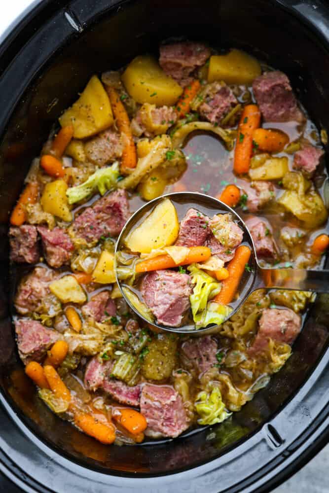 Corned Beef and Cabbage slow cook all day with hearty vegetables making one delicious stew! This is a classic recipe with nostalgic flavors, and it's so easy to whip up. Corned beef and cabbage stew in a slow cooker.