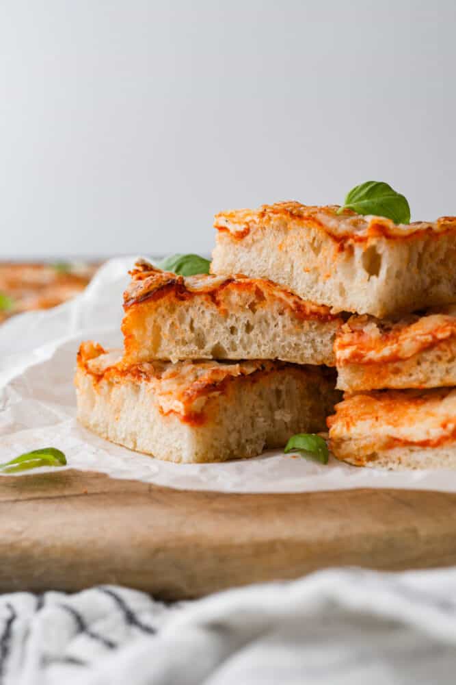 As if focaccia bread wasnโt good enough, now you can level it up with your favorite pizza toppings! Focaccia pizza is cheesy and flavorful, all on top of the most soft and dreamy crust! Slices of pizza stacked on top of each other.