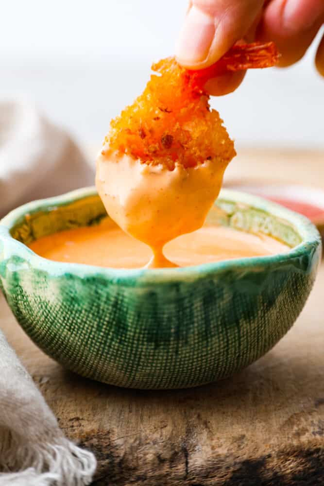 Sriracha mayo is the condiment youโre going to want to put on everything! Itโs creamy and savory, with spice that packs a punch! Dipping fried shrimp into sriracha mayo.