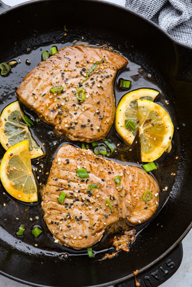 There's no reason to save Tuna Steaks for eating out, make them yourself for a gourmet restaurant experience in the comfort of your home. Not only are they full of healthy nutrients, they are delicious and a real treat any day of the week. Seared tuna steaks in a pan.