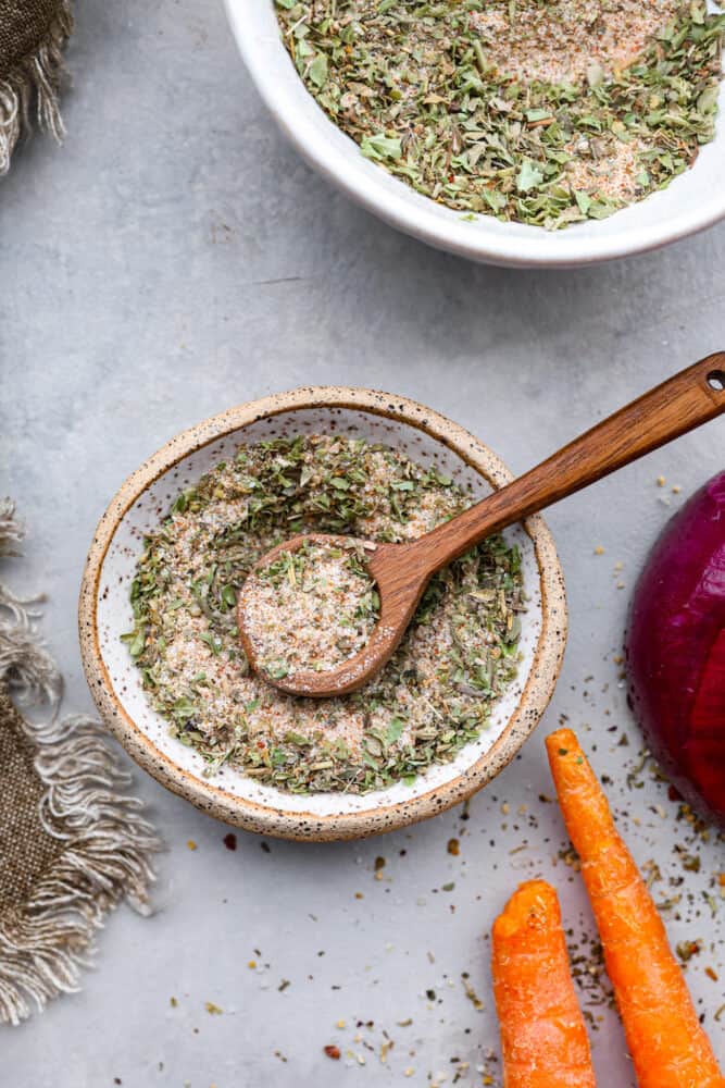 A fresh and homemade vegetable seasoning is just what your pantry needs! Homemade seasonings are so much more flavorful than store-bought versions and have no preservatives. Take 5 minutes to make this blend for all of your cooked veggies. Vegetable seasoning in a bowl with a wooden spoon.