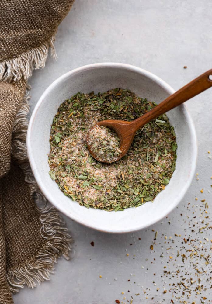 A fresh and homemade vegetable seasoning is just what your pantry needs! Homemade seasonings are so much more flavorful than store-bought versions and have no preservatives. Take 5 minutes to make this blend for all of your cooked veggies. Vegetable seasoning in a bowl with a wooden spoon.