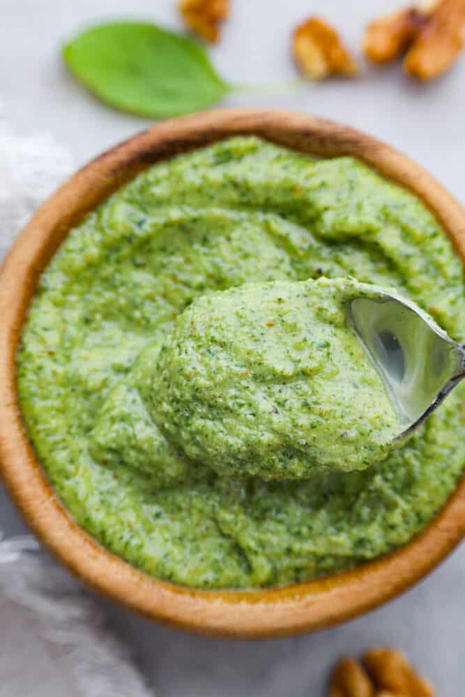 Move over, traditional basil pesto, there's a new nut in town! Walnut pesto is the perfect combination of earthy, nutty goodness with just the right amount of zing. You won't want it any other way. Spread it on chicken, toss it with pasta, or even eat it by the spoonful- no judgement here! Closeup of a spoonful of pesto.