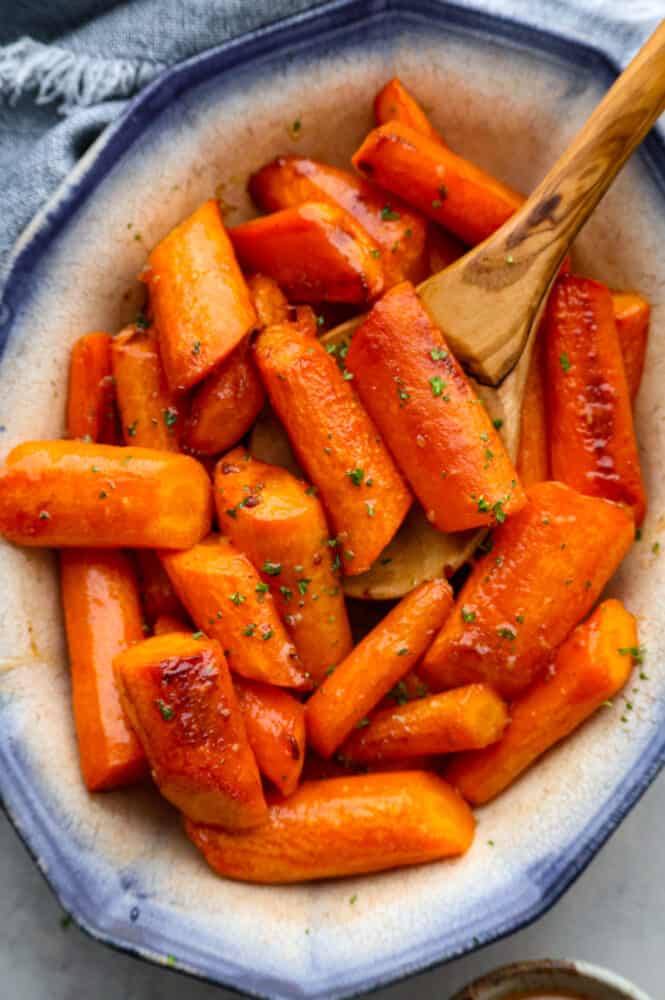 Roasted brown butter honey garlic carrots make an excellent side dish. Roasted to tender perfection in the most incredible sauce these will instantly become a new favorite! Top-down view of roasted carrots.