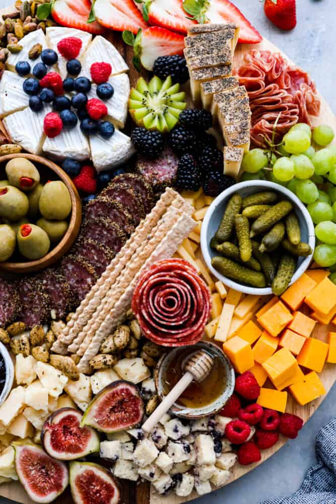 Charcuterie boards are the ultimate party trick that never fail to impress! These beautiful displays of meats, cheeses, fruits, and nuts are not only eye-catching but also incredibly delicious. Don't be intimidated by how Pinterest-worthy they look, because assembling one is a lot easier than you think. Here are all the ins and outs on how to make a charcuterie board at home! Top-down view of a charcuterie board.