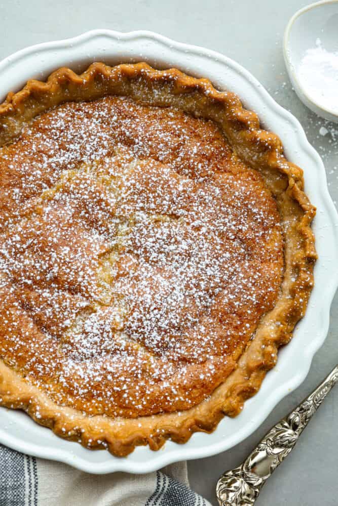 This classic Southern dessert is a delicious combination of sweet, tangy, and buttery flavors all wrapped up in a flaky crust. Its custard-like filling has a smooth and creamy texture that will have you hooked. And the best part? Chess pie is super easy to make and only takes 10 minutes of prep! Top-down view of a whole chess pie.