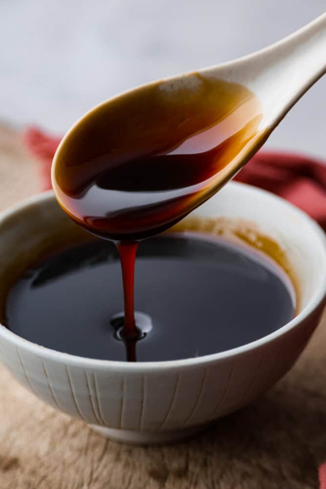 Eel sauce, also called Unagi sauce, is a thickened and sweetened soy sauce that is perfect for dipping or drizzling. It doesn't actually contain any eel products and is a sweet and sticky sauce perfect for topping any fish or sushi. Eel sauce being poured out of a spoon into a bowl.