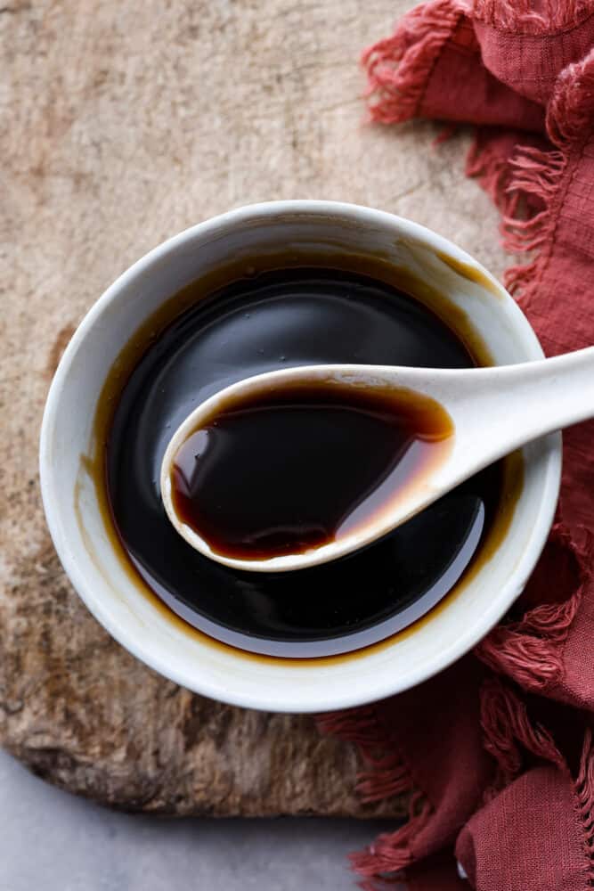 Eel sauce, also called Unagi sauce, is a thickened and sweetened soy sauce that is perfect for dipping or drizzling. It doesn't actually contain any eel products and is a sweet and sticky sauce perfect for topping any fish or sushi. An overhead view of eel sauce in a bowl with a spoon.