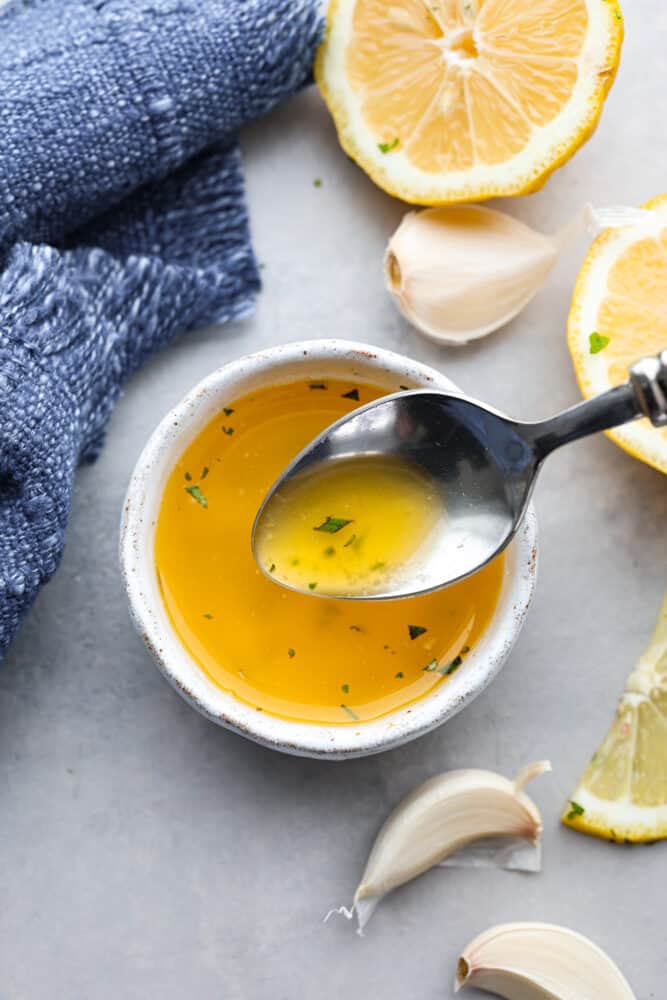There's really nothing better than this homemade garlic butter sauce. It's rich, savory, and perfect for seafood, pasta, veggies, and more! Trust me when I say you'll want to put it on everything. Garlic butter sauce in a small white bowl.