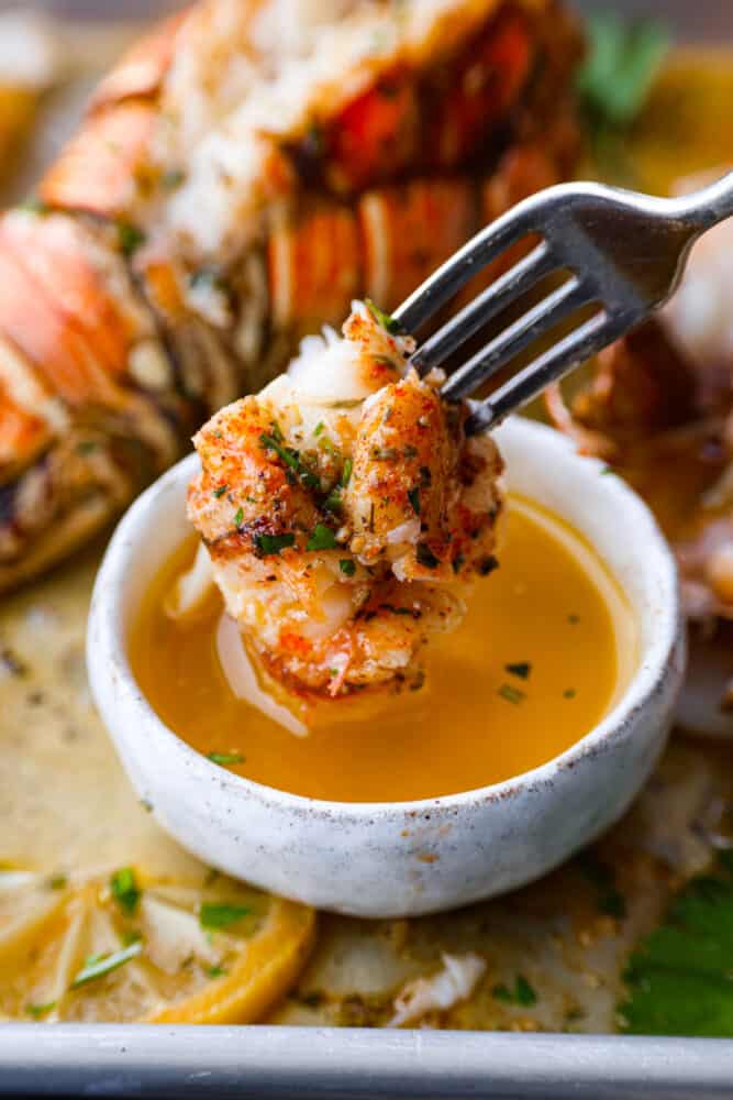 There's really nothing better than this homemade garlic butter sauce. It's rich, savory, and perfect for seafood, pasta, veggies, and more! Trust me when I say you'll want to put it on everything. Dipping lobster into the garlic butter sauce.