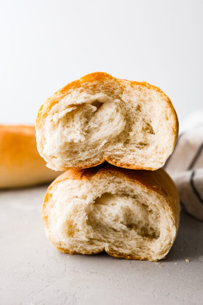 Skip the bakery and make your own artisan Italian bread at home! This bread is perfect for subs and sandwiches of every kind. Besides, no one can resist the smell of fresh bread hot out of the oven! Two halves of Italian bread stacked on top of each other showing the inside.