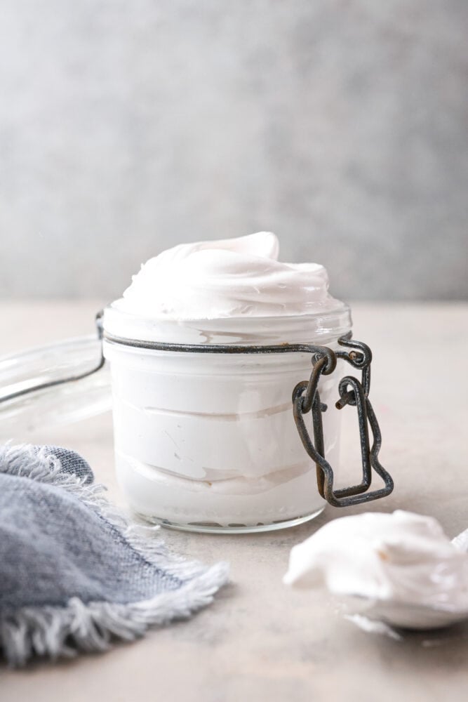 Life is short, make some marshmallow fluff! It’s like a cloud made of sugar and is the ultimate sweet treat. It works as a great topping, cake filling and fruit dip, but is also perfect for eating straight from the jar. I won’t tell! Front view of homemade marshmallow fluff in a glass jar.