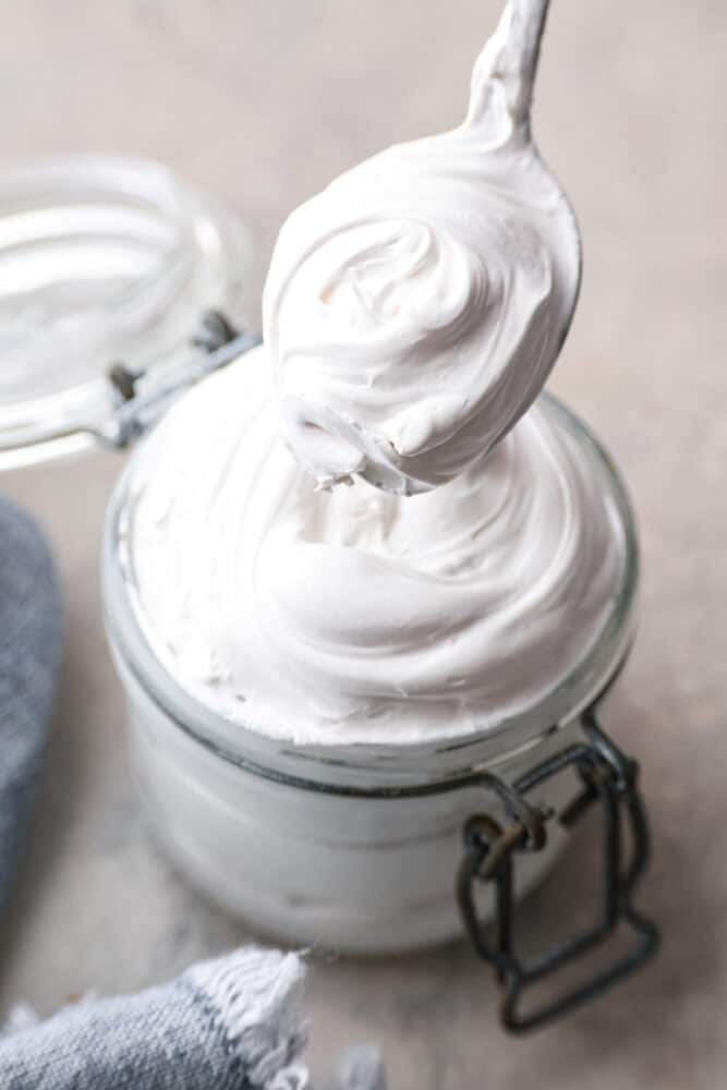 Life is short, make some marshmallow fluff! It’s like a cloud made of sugar and is the ultimate sweet treat. It works as a great topping, cake filling and fruit dip, but is also perfect for eating straight from the jar. I won’t tell! Closeup of a jar filled with marshmallow fluff