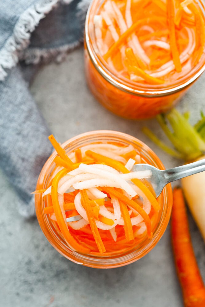 My pickled carrots and daikon are the zesty upgrade your meals didn’t know they needed! Made with rice vinegar, they’re a little sweeter and less sharp than typical pickled veggies. An overhead view of the pickled carrots.