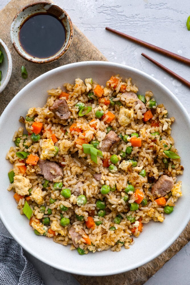 You guys know how I feel about fried rice, itโs my go-to for leftover rice and whatever meatโs in the fridge. Pork Fried Rice is savory and satisfying. With tender pork, fluffy eggs, and veggies all in one pan, itโs the ultimate weeknight win. A bowl of pork fried rice.