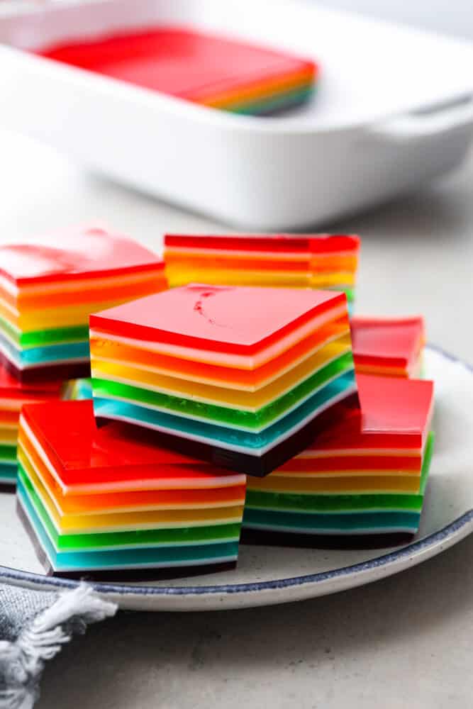 Taste the Rainbow! Whether it's a birthday party, St. Patrick's Day, or just a fun summer BBQ, rainbow Jello is always a crowd-pleaser. Plus, who doesn't love a dessert that's literally bursting with color? Cubed rainbow jello stacked on top of each other.
