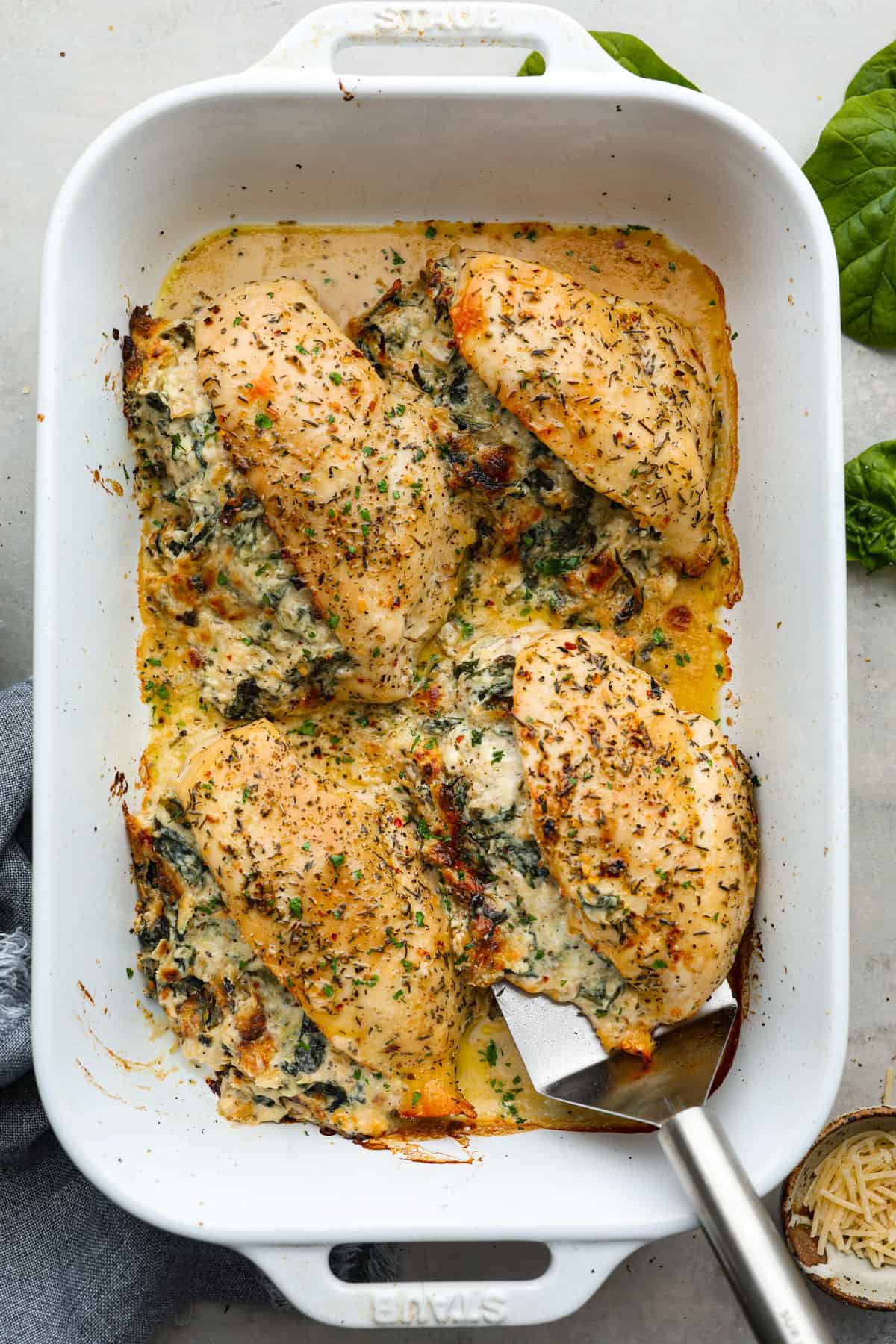 Do you love spinach dip as much as I do? My Spinach Stuffed Chicken Breast turns those creamy, cheesy flavors into an insanely delicious dinner. Quick, easy, and seriously so good. Overhead shot of cooked chicken.