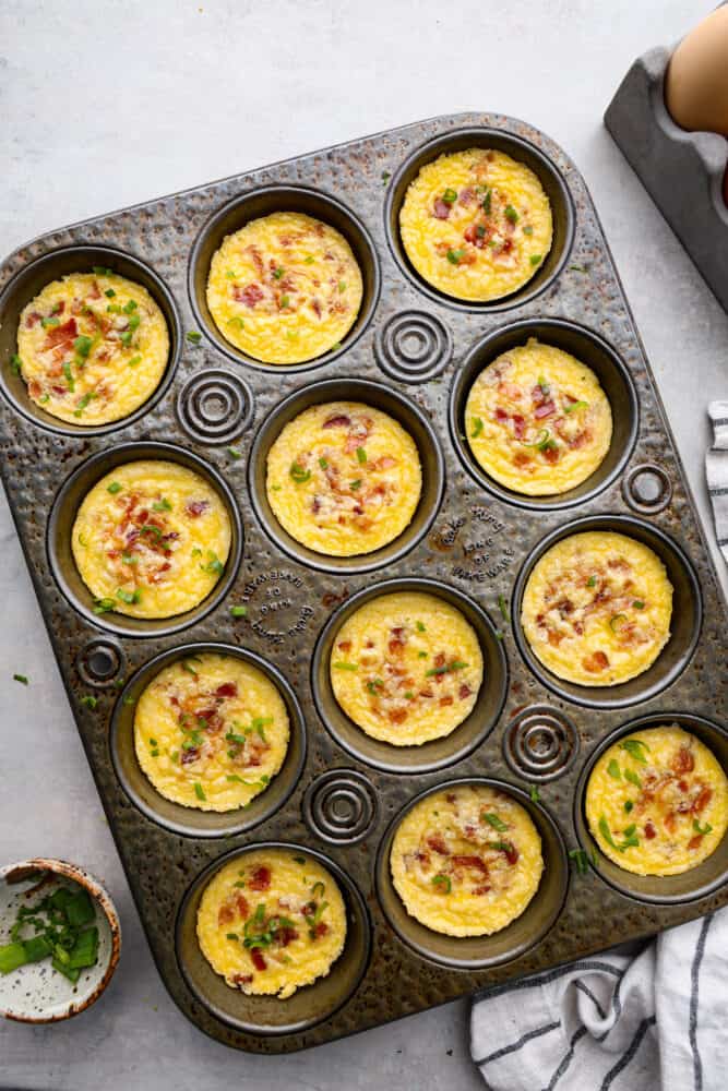 Iโve been hooked on Starbucks egg bites for years, but not the price! This homemade version is just as fluffy and flavorful, and makes the perfect grab-and-go, protein-packed breakfast. An overhead view of the Starbucks egg bites in a muffin pan.