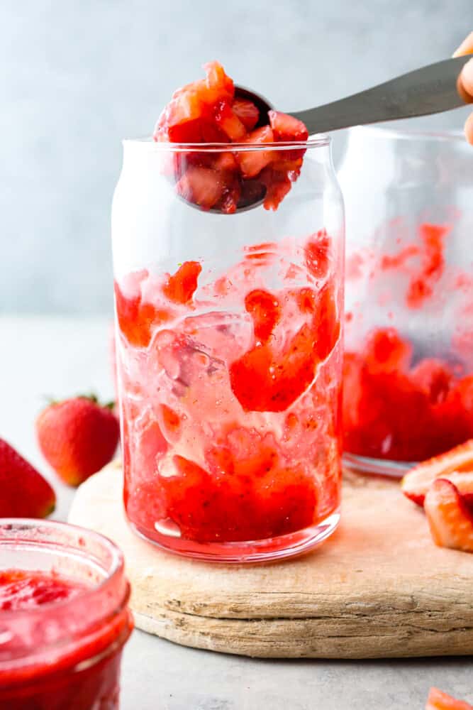 Homemade Korean strawberry milk is a sweet and fruity treat that is sure to satisfy your taste buds. The blend of fresh strawberries and creamy milk creates a perfectly balanced flavor that is both indulgent and refreshing. Sipping on a glass of this cute and tasty beverage brings the café culture of Seoul straight to your kitchen! Adding chopped strawberries to a glass cup.