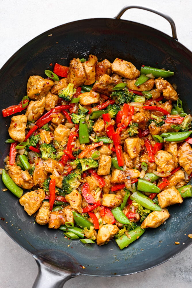 Szechuan chicken is all about bold flavors, with the perfect balance of heat, sweetness, and tanginess. And the best part? It's way better than the takeout version! Let's fire up those taste buds and get cooking! Top-down view of Szechuan chicken in a wok.