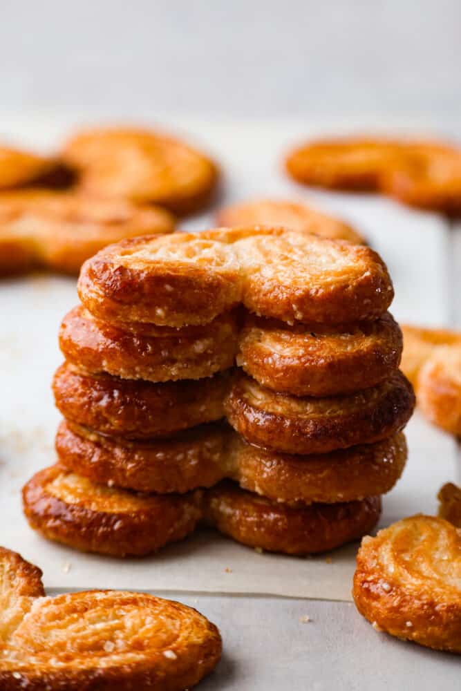 Palmiers, or "palm trees" in French, are a delightful pastry shaped like a palm leaf. With a buttery, flaky texture that's impossible to resist, enjoy one fresh out of the oven and prepare to be amazed. 5 palmiers stacked on top of each other.