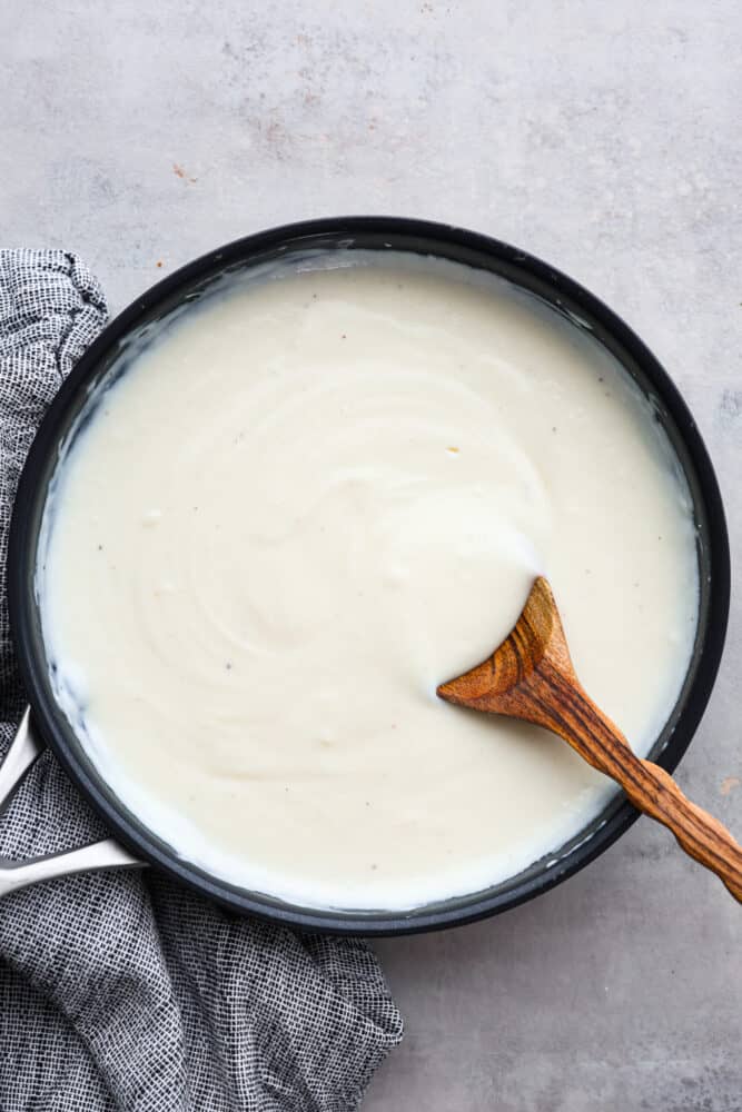 Bechamel sauce is just the creamy, dreamy sauce you need in your life! It's smooth and velvety and can be used in a variety of dishes, from mac and cheese to lasagna. Once you get a taste of its creamy, subtly savory flavor, you'll be hooked! Top-down view of bechamel sauce.