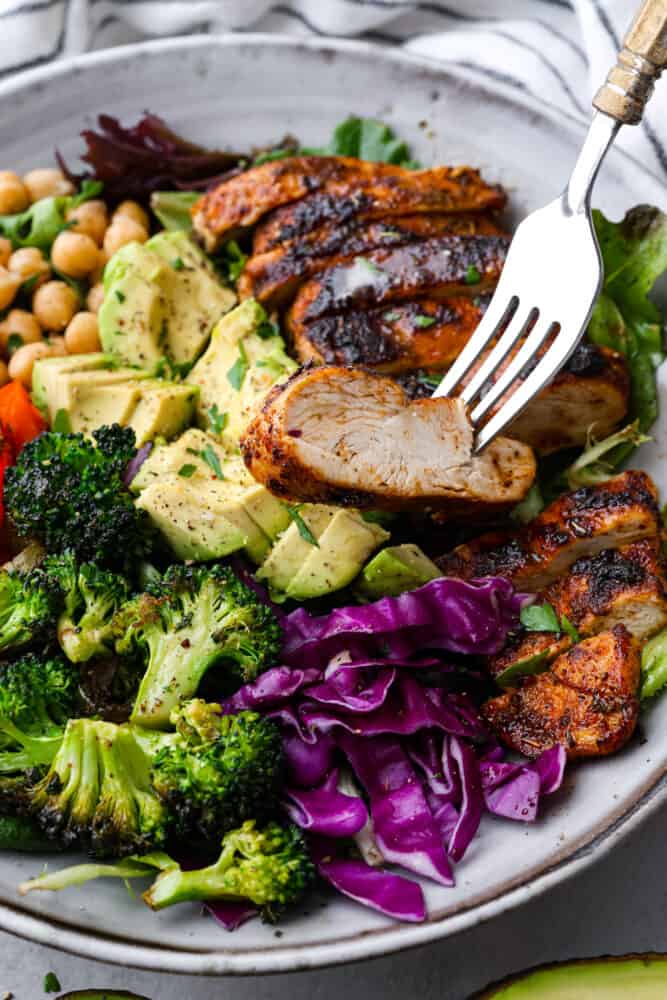 Blackened Chicken Avocado Power Bowls have the best spiced rubbed blackenendย chicken with so many power foods! Avocado, chickpeas, red cabbage and roasted veggies come together in this healthy and flavorful bowl!ย