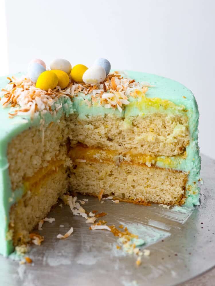 This Easter cake is absolutely divine! A perfectly moist cake with a lemon curd filling and a delicious buttercream frosting will be sure to get a "WOW!" From all of your guests this Easter season!