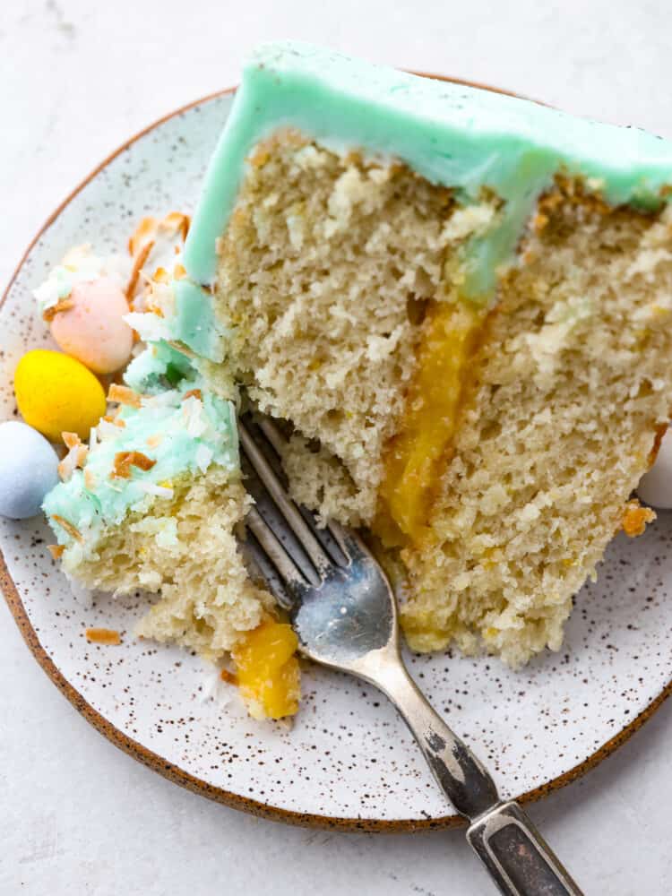This Easter cake is absolutely divine! A perfectly moist cake with a lemon curd filling and a delicious buttercream frosting will be sure to get a "WOW!" From all of your guests this Easter season!