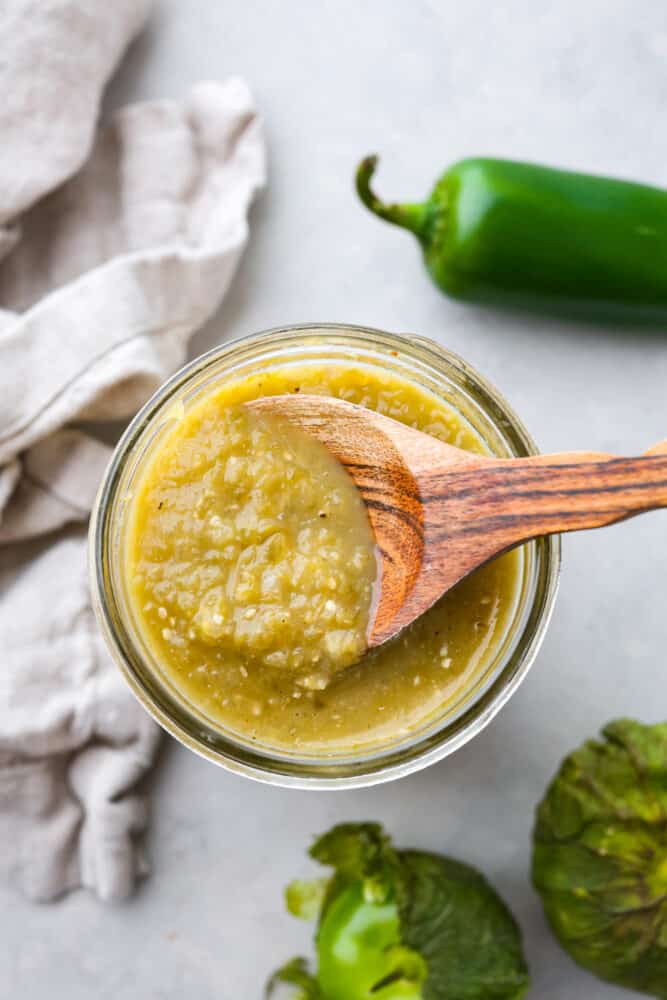If you have some favorite enchiladas that are in need of a delicious sauce, look no more! This Homemade Green Enchilada Sauce is so delicious and packed with flavor. You will want to have it on hand all the time! The top view of enchilada sauce in a jar.