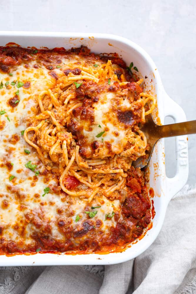 This Million Dollar Spaghetti casserole has the perfect name- it really tastes like a million bucks! It's the perfect combination of lasagna and spaghetti, how can it get better than that? An overhead view of a piece of million dollar spaghetti.