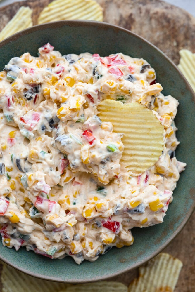 Loaded Creamy Ranch Dip is packed with so many delicious flavors that friends and family won't be able to get enough of it. Perfect for the pool or potlucks! A closeup of a bowl of creamy ranch dip.
