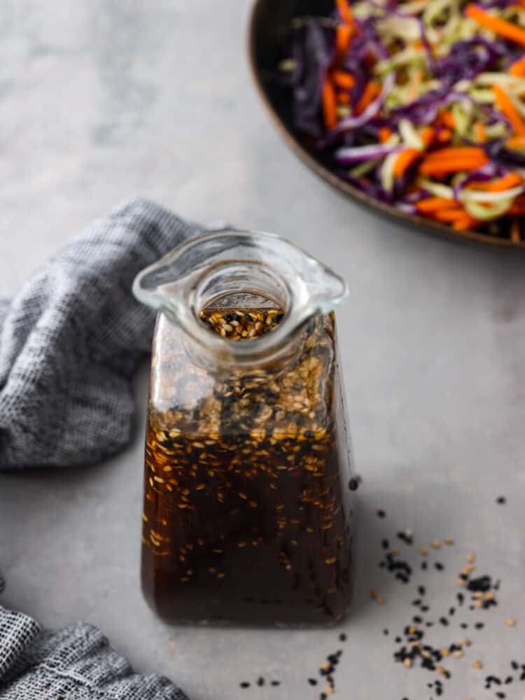 Packed with tangy, savory flavor, and sesame seeds for texture, this homemade Asian salad dressing is the perfect addition to your favorite bowl of greens. It’s made without preservatives and artificial flavors for a dressing you can feel great about using! Top-down view of a bottle of Asian salad dressing.